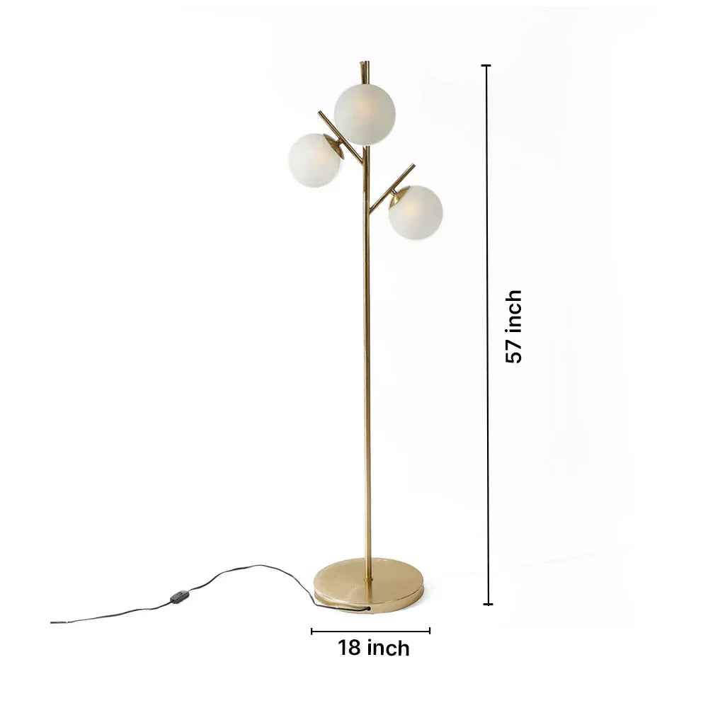 Gold floor lamp with three white globe lights